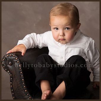 One year old child celebrating a first birthday with a classic studio portrait One year old child celebrating a first birthday with a classic studio portrait