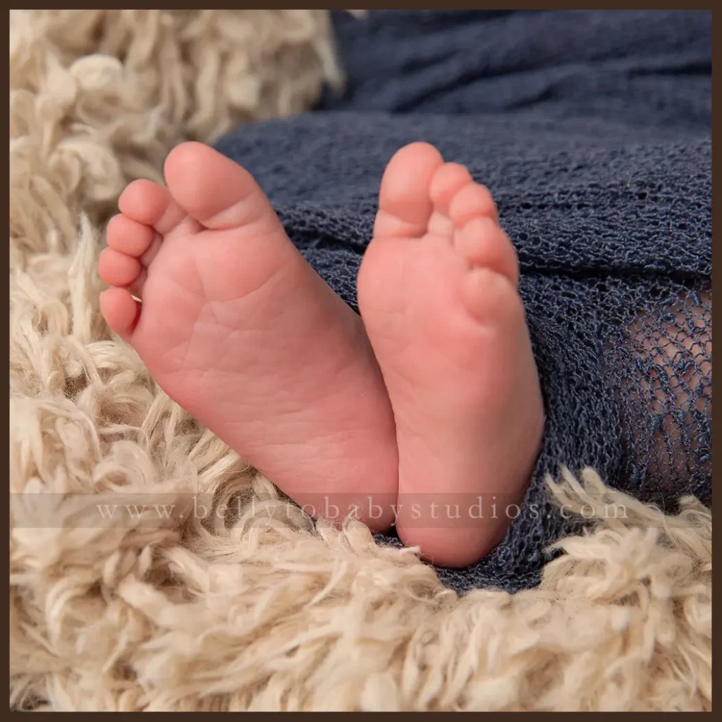 Houston Maternity Photographer Close up newborn portrait capturing tiny feet during a Houston studio session.