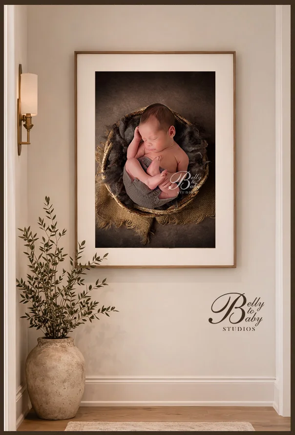 Houston Maternity Photographer Framed newborn portrait artwork displayed in a family hallway.