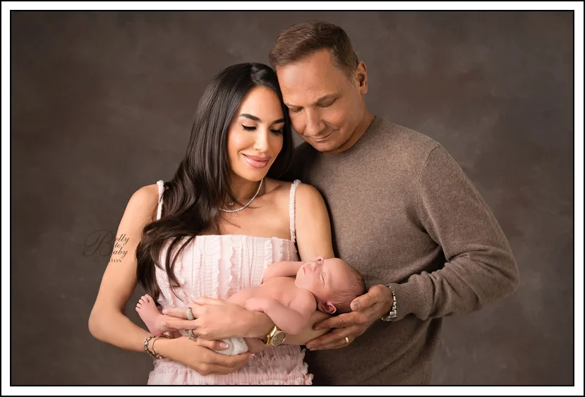 Houston Maternity Photographer Houston newborn family portrait featuring parents and their newborn baby photographed at Belly to Baby Studios.