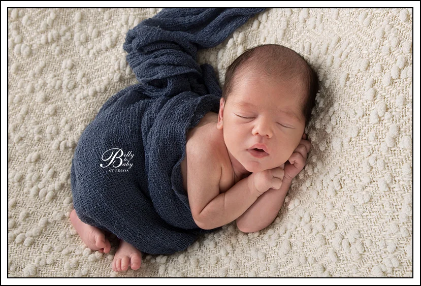 Houston Maternity Photographer Newborn baby wrapped in neutral swaddle during Houston newborn photography session.