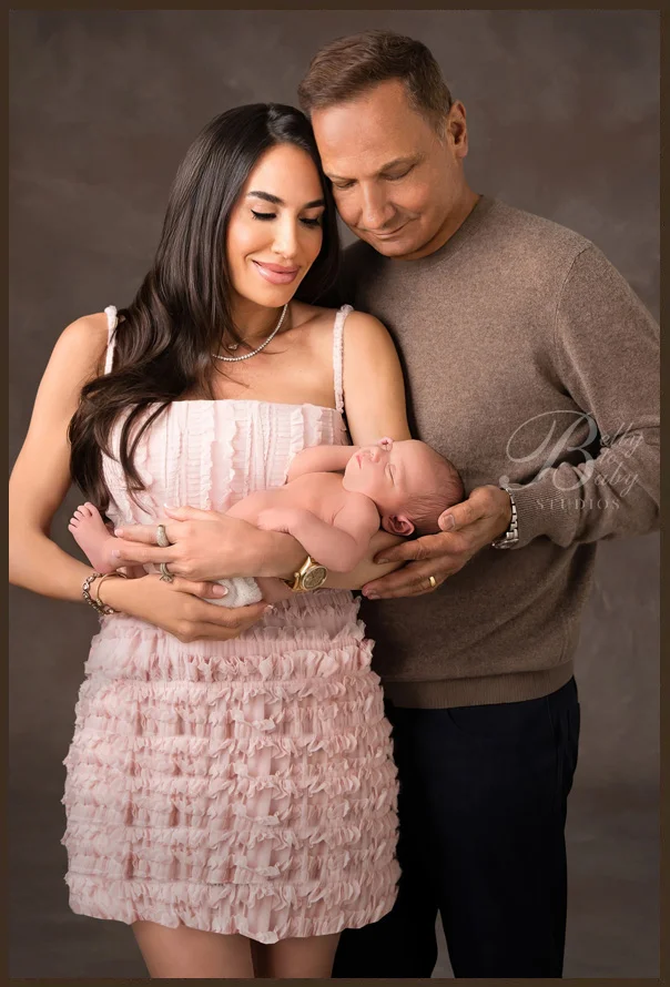 Houston Maternity Photographer Houston newborn family portrait featuring parents and their newborn baby photographed at Belly to Baby Studios.