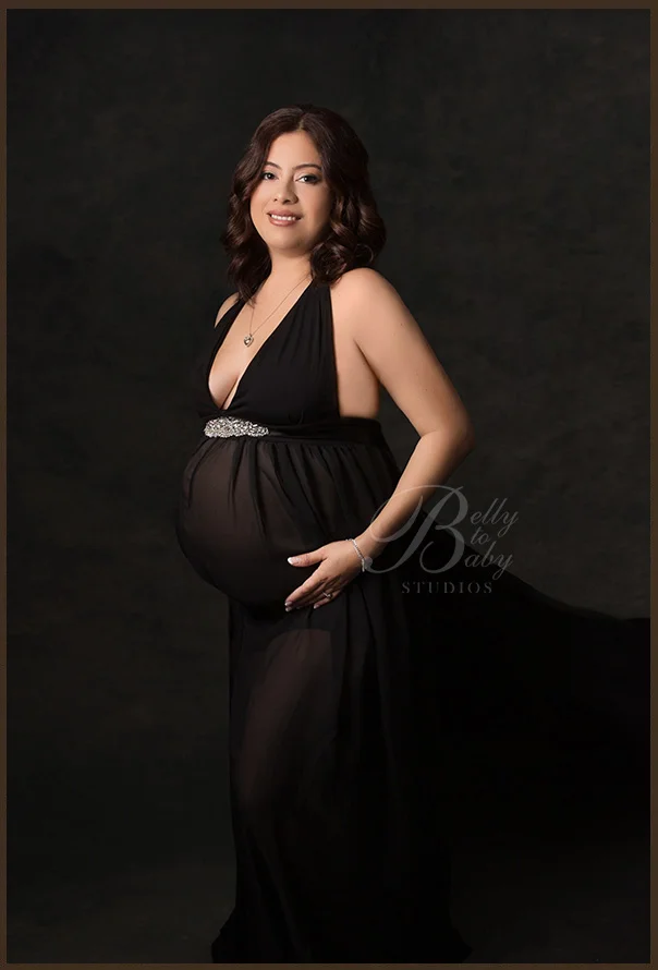 Houston Maternity Photographer What to Wear for Maternity Photos in Houston Studios featuring an expectant mother wearing an elegant flowing black maternity gown
