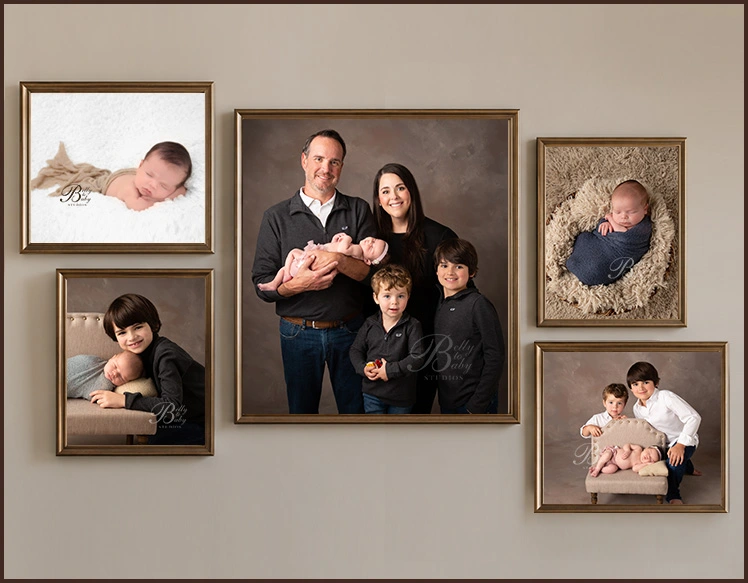 Wall display of framed baby and child portraits arranged in a gallery-style portrait collection. Wall display of framed baby and child portraits arranged in a gallery-style portrait collection.