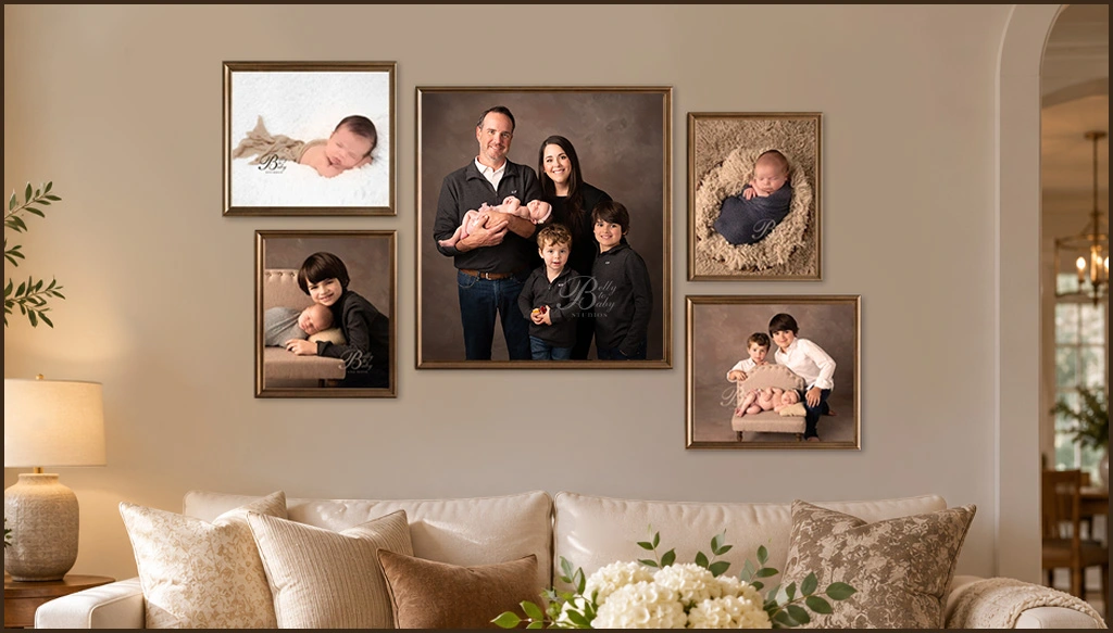 Gallery wall of framed family portraits and baby milestone photography displayed above a living room sofa in a warm, neutral home. Gallery wall of framed family portraits and baby milestone photography displayed above a living room sofa in a warm, neutral home.