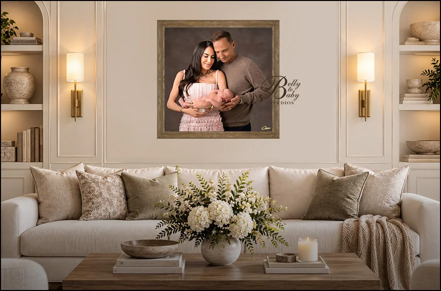 Houston Maternity Photographer Houston newborn family portrait displayed above a cream sofa in an elegant living room by Belly to Baby Studios