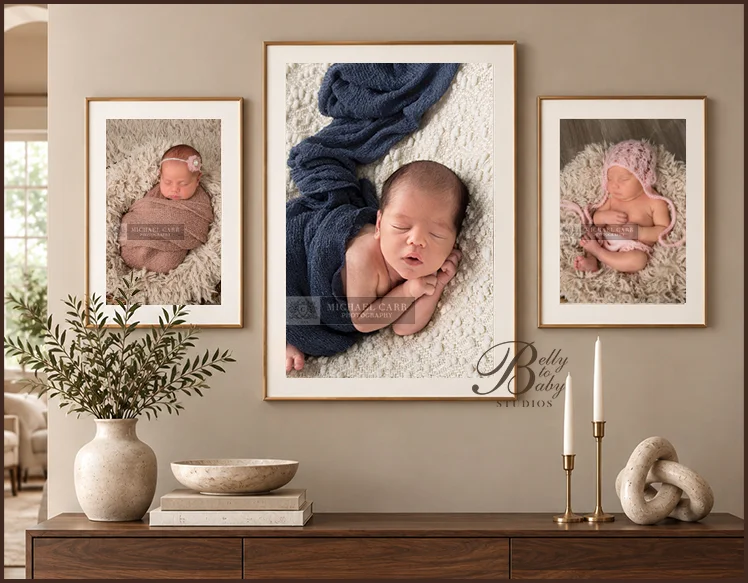 Three framed newborn portraits displayed above a wooden console table with neutral decor in a warm, modern home. Three framed newborn portraits displayed above a wooden console table with neutral decor in a warm, modern home.